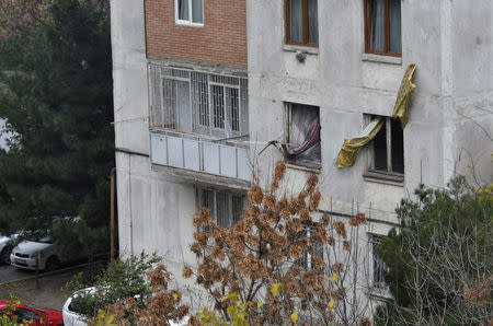 Curtains are seen in destroyed windows of an apartment block during an operation to apprehend people suspected of terrorism according to local media, in Tbilisi Georgia November 22, 2017. REUTERS/Irakli Gedenidze