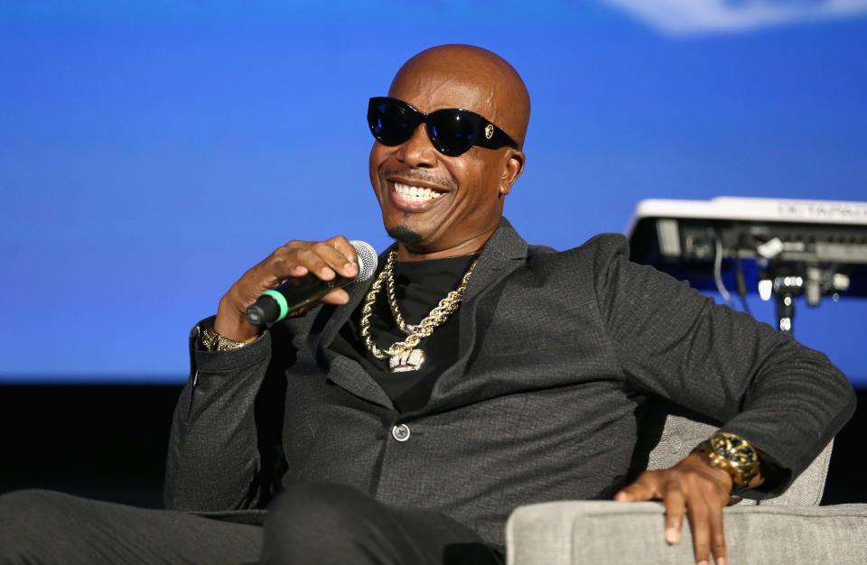 MC Hammer smiling and holding a microphone