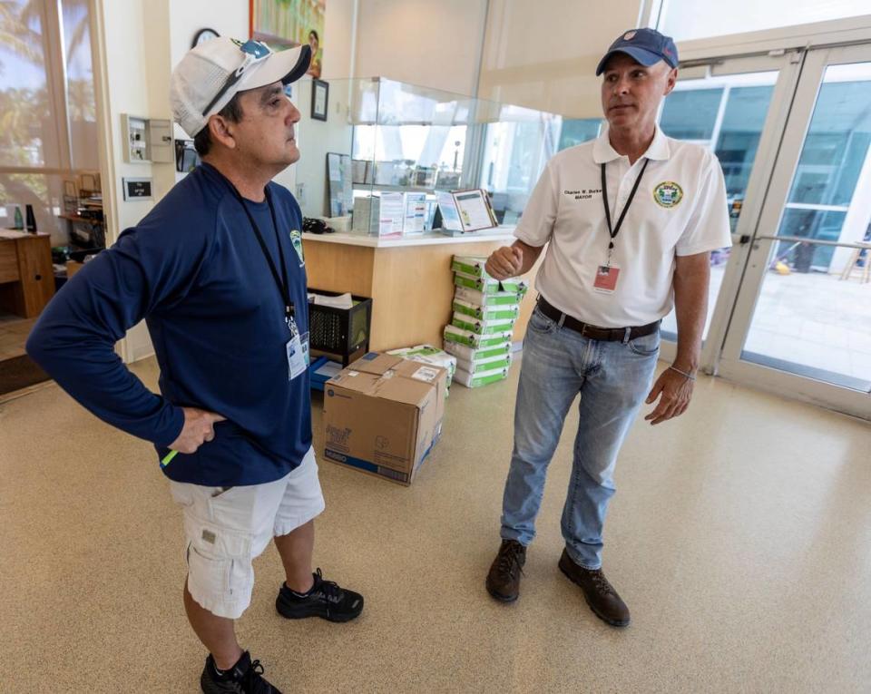 Surfside Mayor Charles Burkett, right, talks to Surfside’s Parks and Recreation Director Tim Milian inside the Surfside Community Center on July 15, 2021. The center resumed its summer camp program after the building was converted into an emergency resource hub for evacuated residents and victims’ families after Champlain Towers South fell.