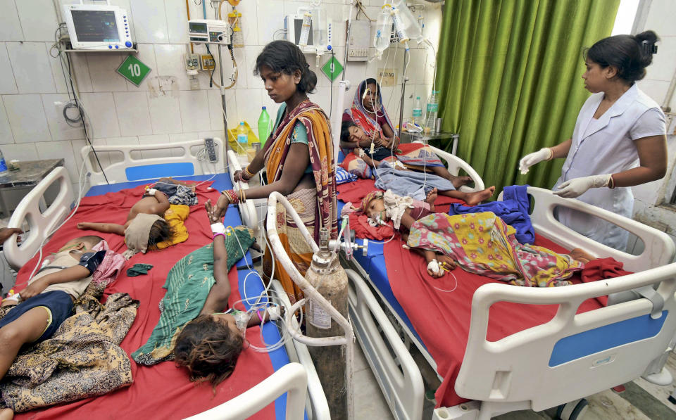 In this Tuesday, June 18, 2019 photograph, children showing symptoms of acute encephalitis syndrome undergo treatment at Sri Krishna Medical College Hospital in Muzaffarpur, Bihar state, India. More than 100 children have died in an encephalitis outbreak in India's eastern state of Bihar, authorities said Tuesday. (AP Photo/Aftab Alam Siddiqui)