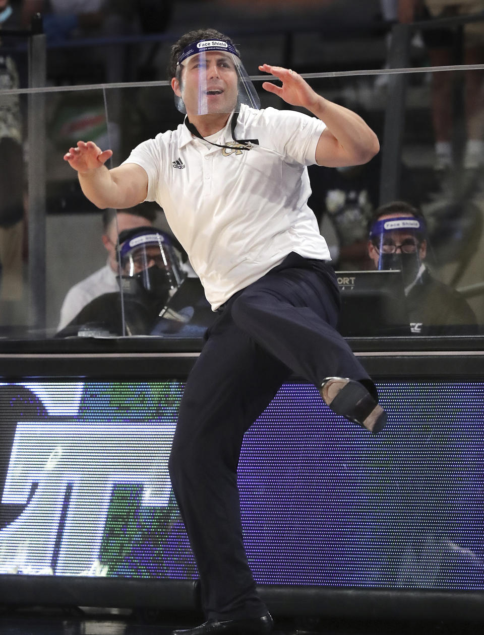 Georgia Tech head coach Josh Pastner uses some body English and a leg kick while coaching his team to a come from behind 72-67 victory over North Carolina during an NCAA college basketball game Wednesday, Dec. 30, 2020, in Atlanta. (Curtis Compton/Atlanta Journal-Constitution via AP, Pool)