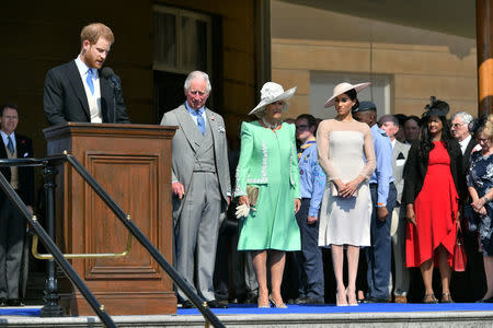 Britain's Prince Harry and his wife Meghan, Duchess of Sussex, at a garden party at Buckingham Palace with Prince Charles and Camilla the Duchess of Cornwall, their first royal engagement as a married couple, in London, May 22, 2018. Dominic Lipinski/Pool via Reuters