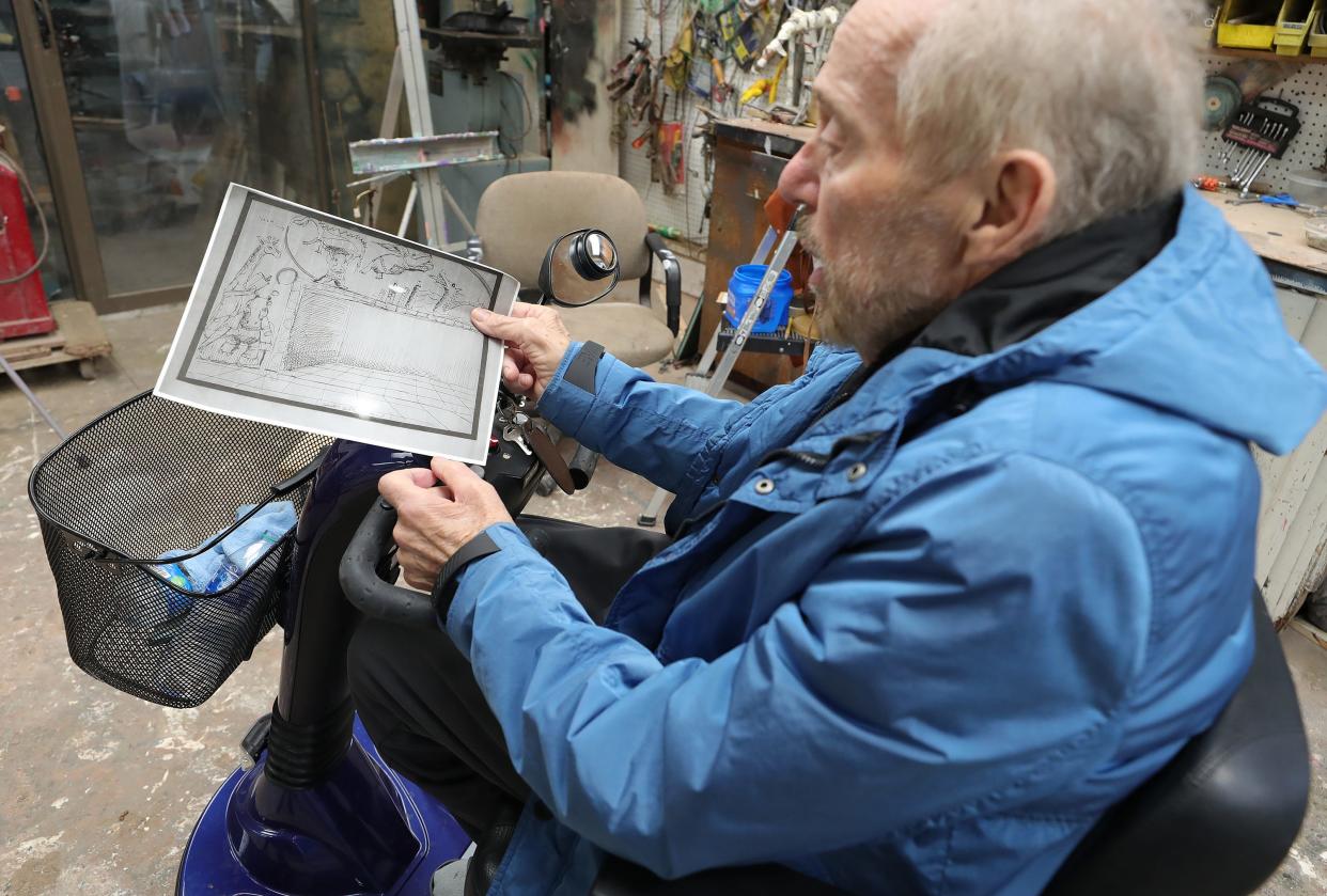 Virgil Villers discusses his artistic process as he shows a sketch proposal he drew for a piece in Wadsworth at his home studio, Wednesday, March 27, 2024, in Norton, Ohio.