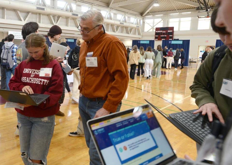 Falmouth High School student Anna Velesig gets some pointers on Friday from realtor Heath Coker at a Credit For Life financial planning workshop for Falmouth High School seniors.