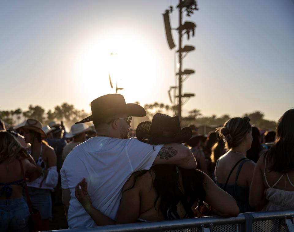 A couple embraces while listening to a set by Elle King on the Mane stage at Stagecoach at the Empire Polo Club in Indio, Calif., Friday, April 28, 2023. 