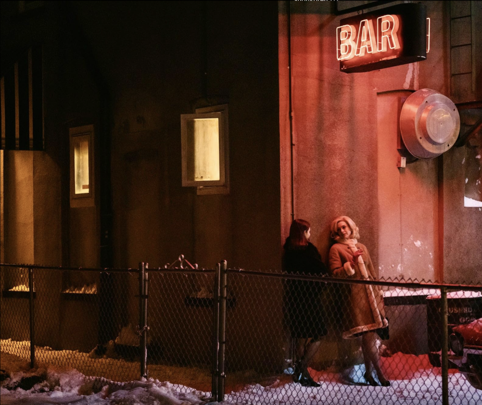 a couple of people standing outside a building