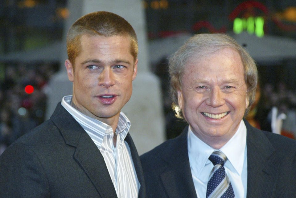 FILE - Actor Brad Pitt, left, and German director Wolfgang Petersen appear at the world premiere of the film "Troy" in Berlin, Germany, on May 9, 2004. Petersen, the German filmmaker whose WWII submarine epic “Das Boot” propelled him into a blockbuster Hollywood career, died Friday at his home in the Los Angeles neighborhood of Brentwood after a battle with pancreatic cancer. He was 81. (AP Photo/Jan Bauer, File)