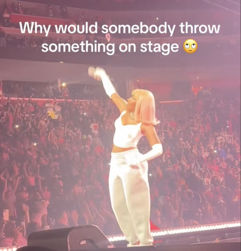 Nicki Minaj on stage with text "Why would somebody throw something on stage ?" expressing surprise