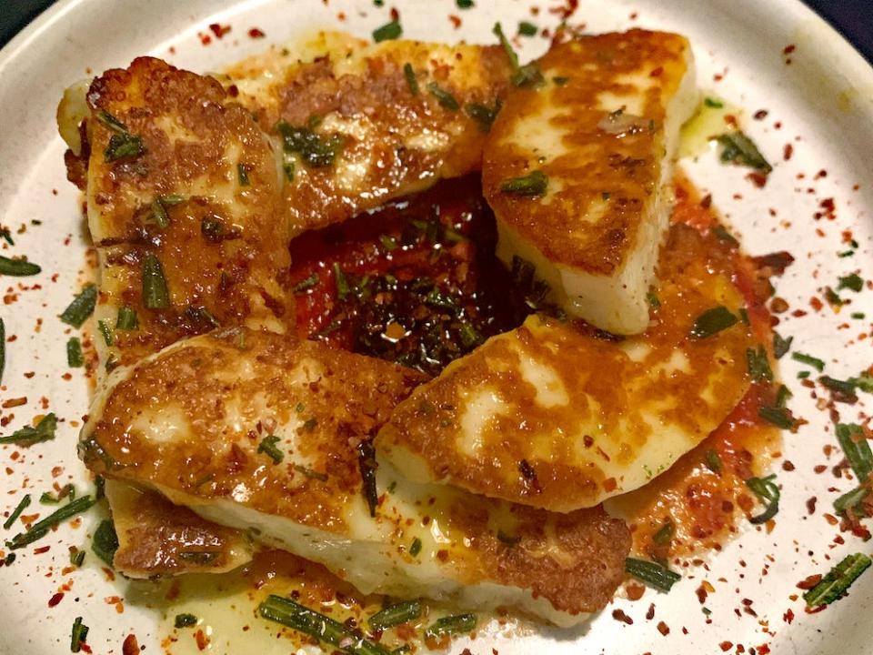 plate of fried halloumi cheese with seasonings