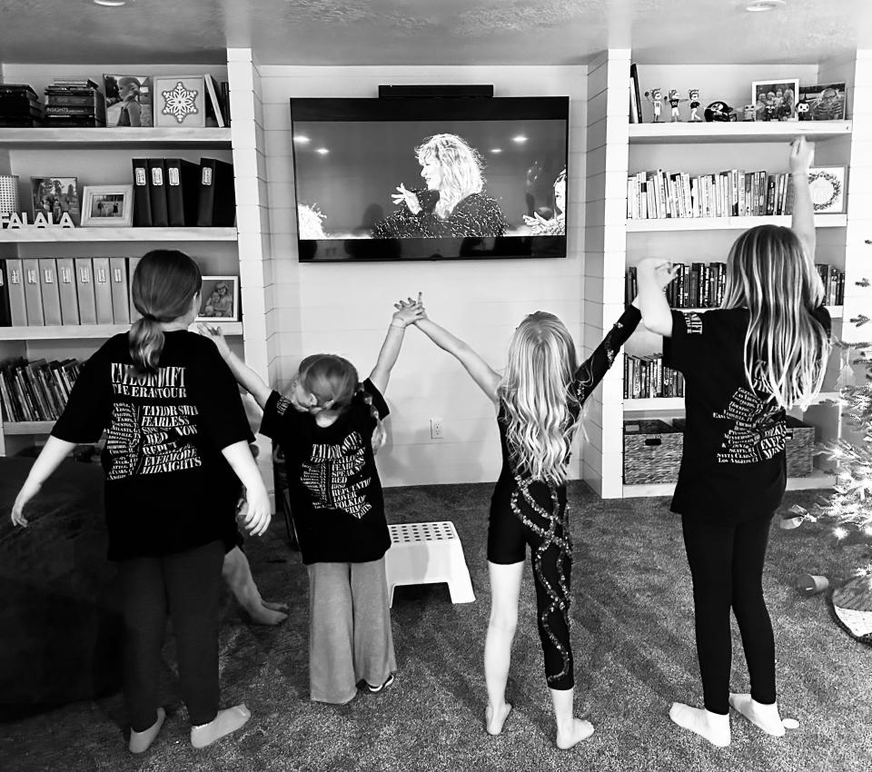 Lucy Llewellyn and three of her neighbors take a bow at the end of “Taylor Swift: The Eras Tour” concert movie their families rented. | Sarah Gambles, Deseret News