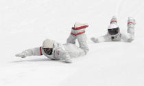 <p>United States snowboard team members slide down the hill after the men’s Big Air snowboard competition at the 2018 Winter Olympics in Pyeongchang, South Korea, Saturday, Feb. 24, 2018. (AP Photo/Matthias Schrader) </p>