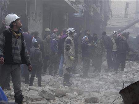 Residents look for survivors at a damaged site after what activists said was an air strike from forces loyal to Syria's President Bashar al-Assad in the Karam Al-Beik area of Aleppo, December 15, 2013. REUTERS/Houssam Al-Halabi