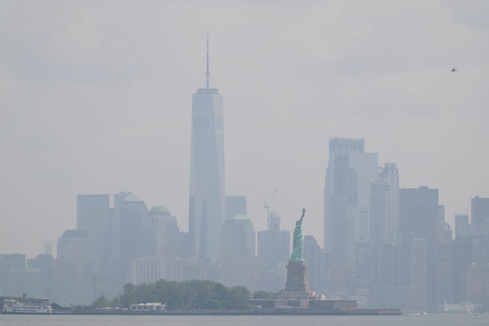 The Statue of Liberty stands in front of a hazy New York City skyline in this view from Jersey City, N.J., Thursday, June 29, 2023.