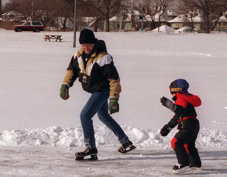 Tom Holmes of Penfield gives skating lesson to his son Robert Holmes (cq), 5, at a pond in Cobbs Hill Park in 1997. Tom used to skate at the pond in the early 1980s.