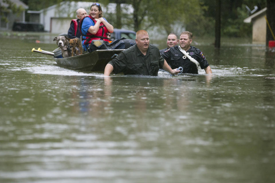 Splendora Police Lt. Troy Teller, left, Cpl. Jacob Rutherford and Mike Jones pull a boat carrying Anita McFadden and Fred Stewart from their flooded neighborhood inundated by rain from Tropical Depression Imelda on Thursday, Sept. 19, 2019, in Spendora, Texas. (Photo: Brett Coomer/Houston Chronicle via AP)