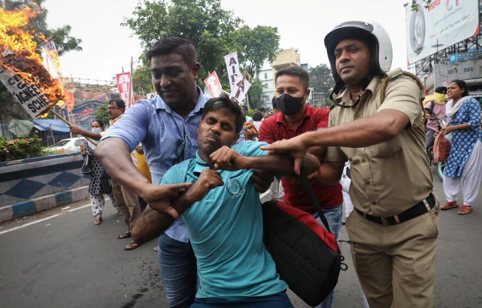 Police detain a demonstrator during a protest against the “Agnipath” scheme (Reuters)