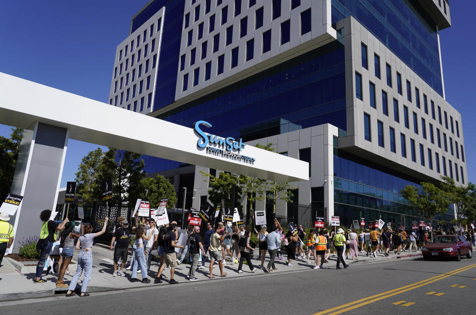 striking writers and actors take part in a rally outside Sunset Bronson studios in Los Angeles on Friday, July 14, 2023. This marks the first day actors formally joined the picket lines, more than two months after screenwriters began striking in their bid to get better pay and working conditions. (AP Photo/Chris Pizzello)