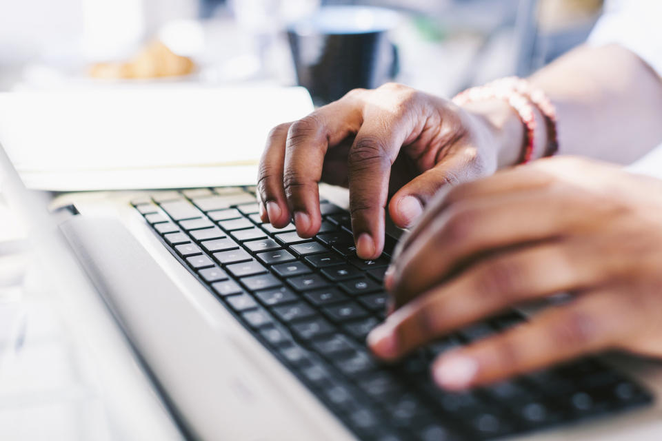 Hands on laptop keyboard.