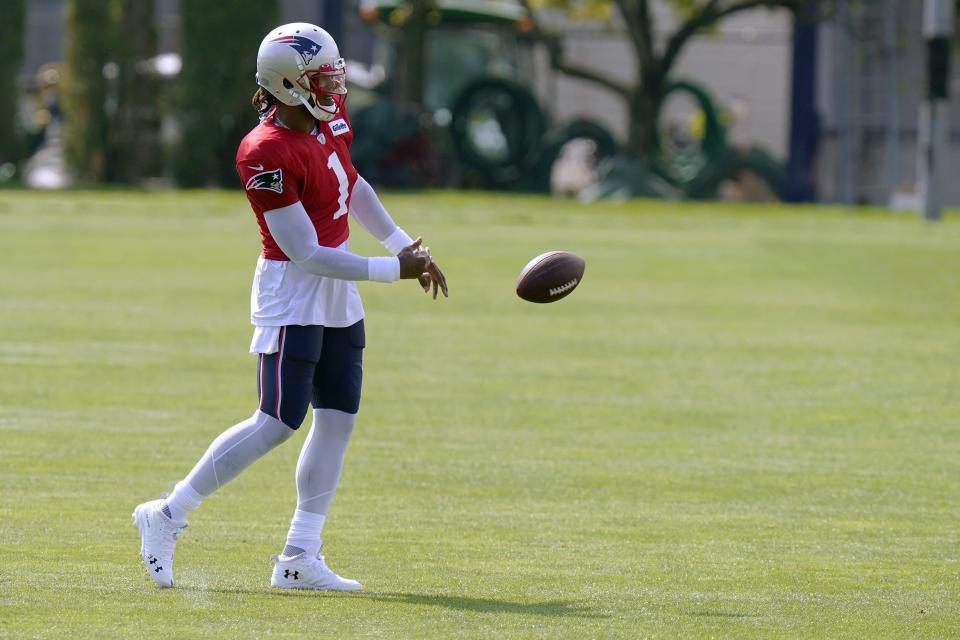 New England Patriots quarterback Cam Newton tosses the football during an NFL football training camp practice, Monday, Aug. 24, 2020, in Foxborough, Mass. (AP Photo/Steven Senne, Pool)