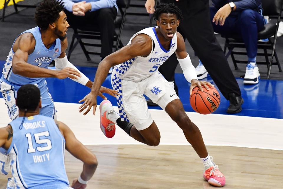 Dec 19, 2020; Cleveland, Ohio, USA;  Kentucky Wildcats guard Terrence Clarke (5) drives to the basket against North Carolina Tar Heels guard Leaky Black (1) during the first half at Rocket Mortgage FieldHouse.