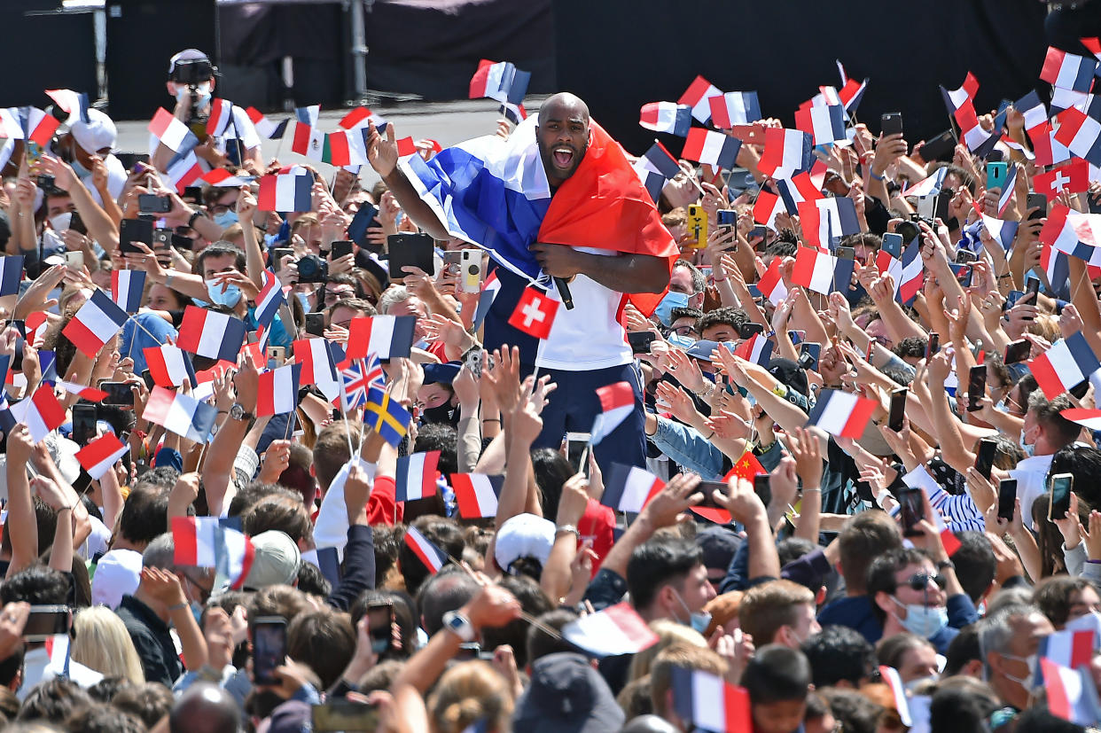 PARIS, FRANCE - AUGUST 08: French Olympic medalist Teddy Riner walks through the crowd during the Olympic Games handover ceremony on August 08, 2021 in Paris, France. On August 8, during the closing ceremony of the Tokyo Olympics, Anne Hidalgo, mayor of Paris, will officially receive the Olympic flag for the handover ceremony to mark Paris 2024 Olympic Games (July 26-August 11) and Paralympics (August 28-September 8). (Photo by Aurelien Meunier/Getty Images)