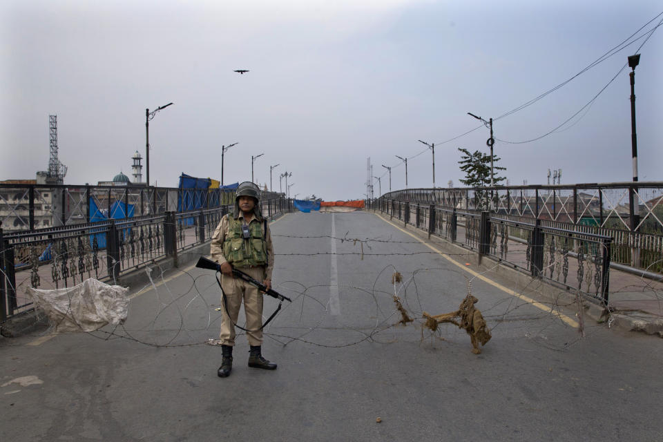 FILE - In this Friday, Sept. 27, 2019, file photo, an Indian paramilitary force soldier stands guard near a barbwire barricade during restrictions in Srinagar, Indian controlled Kashmir. The Trump administration remains concerned about the ongoing crackdown in India-administered Kashmir, the restive Himalayan region stripped of its special constitutional status in August, but supports India's development "objectives" there, Acting Assistant Secretary of State for South and Central Asia Alice Wells said in a statement Tuesday, Oct. 22, ahead of a congressional hearing in Washington. (AP Photo/Dar Yasin, File)