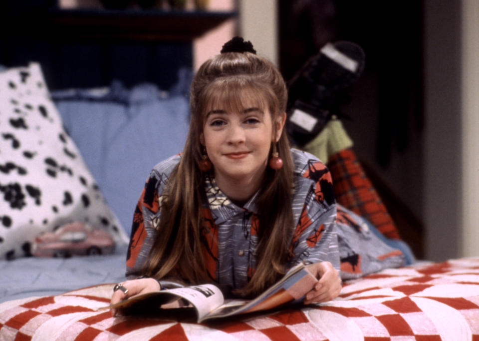 Closeup of Clarissa lying on her bed with a magazine