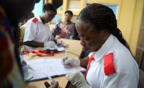 A Congolese health worker records medical data of passengers at the airport in Mbandaka, Democratic Republic of Congo May 19, 2018. REUTERS/Kenny Katombe