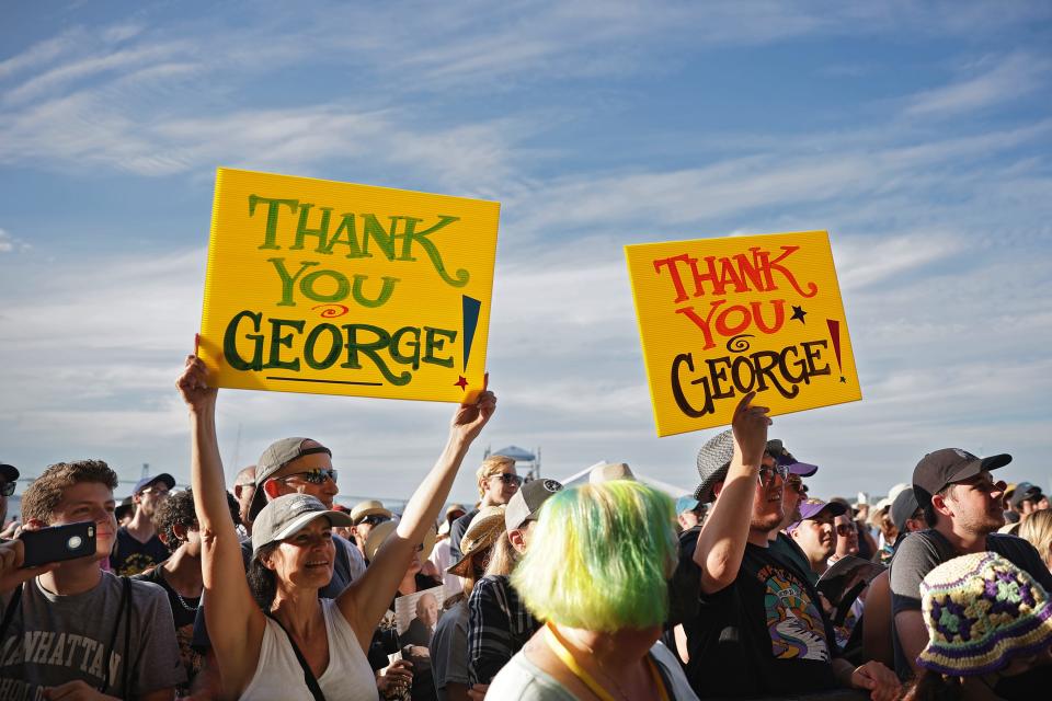 Festival goers hold signs thanking George Wein, founder of the Newport Jazz Festival, on Sunday, July 31, 2022.