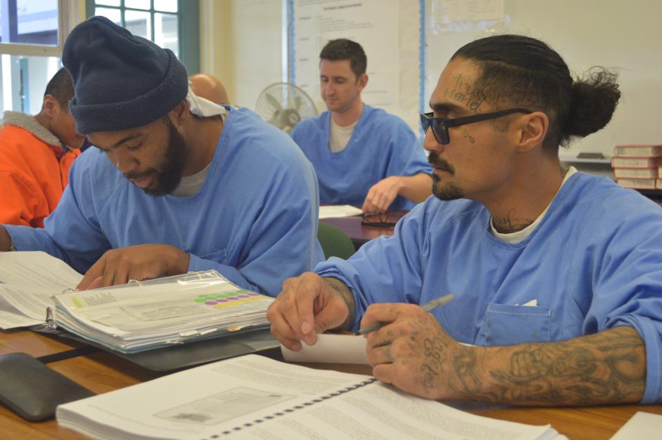 Students at Tehachapi prison work to create oral reports on how various communities in California enforce the 