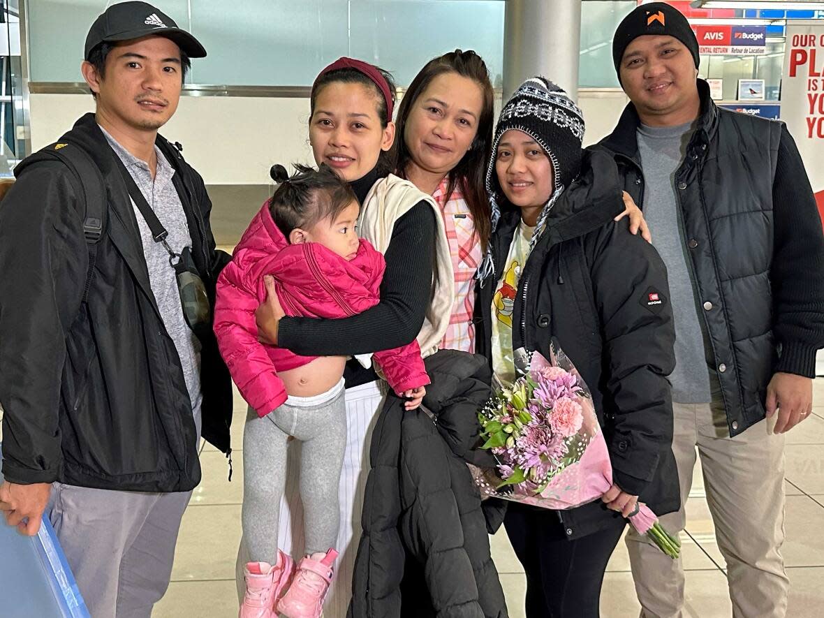 From left to right: Arnel Boyongan, his and April's daughter, Freixine, April Nuval, Joy Thompson, Aubrey Nuval and her husband, Davin Mamaril. (Chris O'Neill-Yates/CBC - image credit)