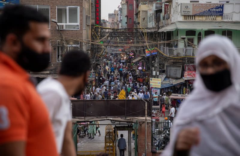 FILE PHOTO: People are seen in a crowded marketplace amidst the spread of the coronavirus disease (COVID-19), in Delhi