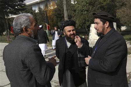 Members of the Loya Jirga, or grand council, talk about a committee session in Kabul November 22, 2013. REUTERS/Omar Sobhani