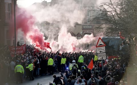 Liverpool's supporters greet their team arriving at the English Premier League soccer match between Liverpool FC and Manchester United held at Anfield  - Credit: REX