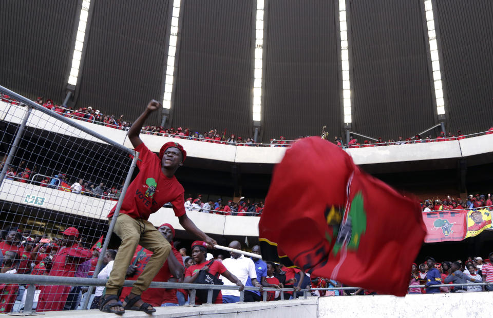 Supporters of Economic Freedom Fighters (EFF) party, dances as he holds a party flag during an election rally at Orlando Stadium in Soweto, South Africa, Sunday, May 5, 2019. Campaign rallies for South Africa’s upcoming election have reached a climax Sunday with mass rallies by the ruling party and one of its most potent challengers. (AP Photo/Themba Hadebe)