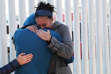 People embrace near the Chaparral border crossing in Tijuana, Mexico, January 25, 2019. REUTERS/Shannon Stapleton