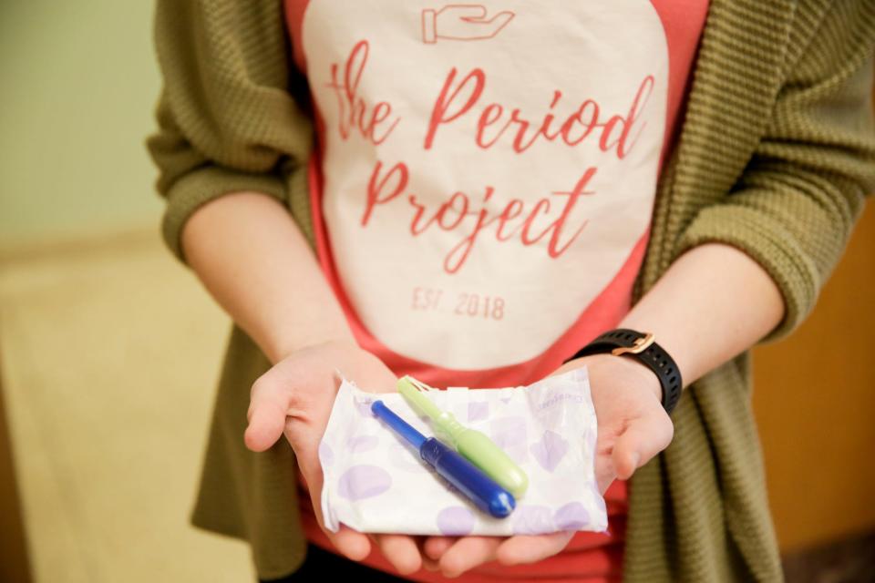 Alison Rickert holds out an assortment of menstrual care products in Purdue University's Stewart Center, Thursday, Feb. 6, 2020, in West Lafayette.