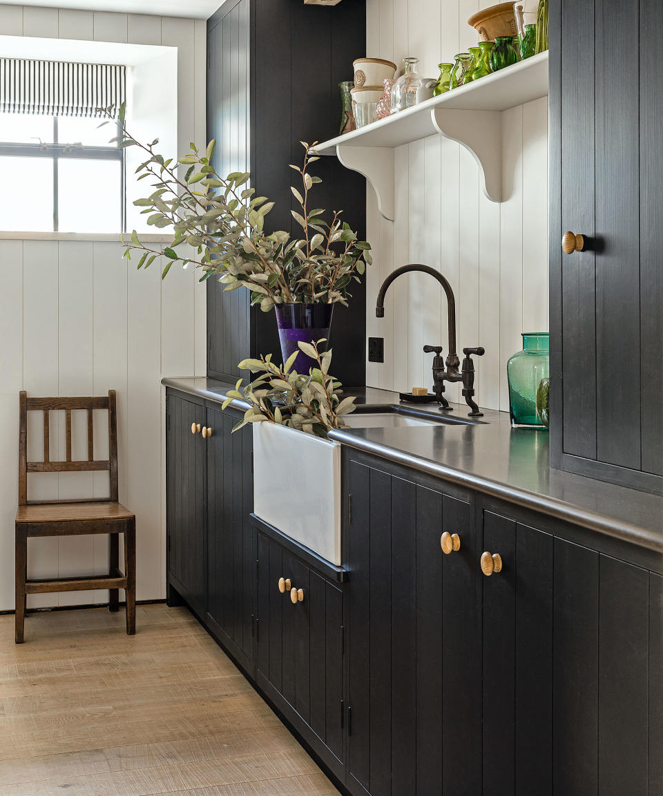 Laundry room with grey cabinets and butler sink