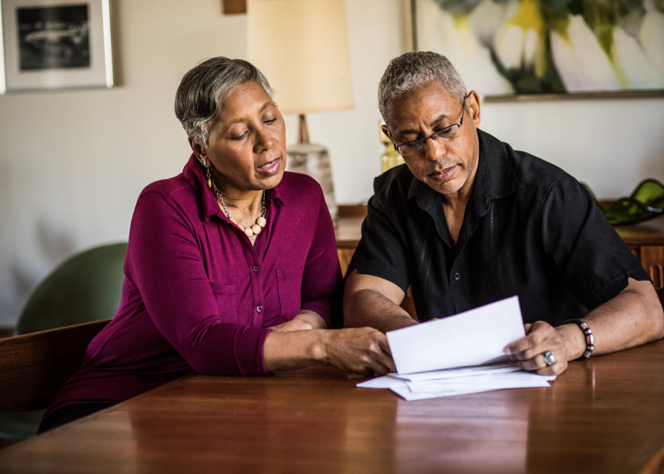 Senior couple (60yrs) paying bills at home