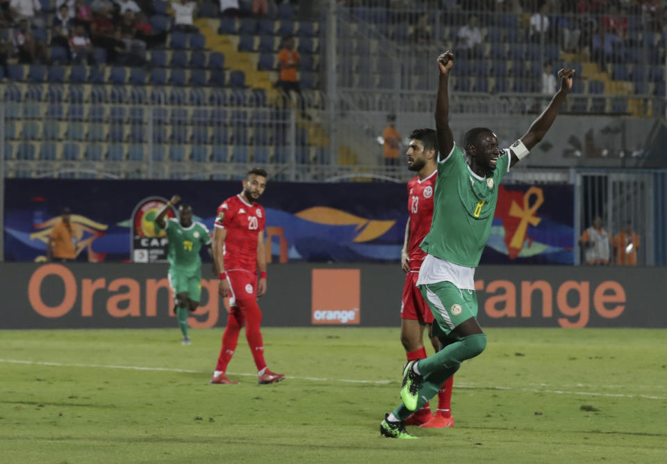 Senegal's Cheikhou Kouyate, left, celebrates after he scored during the African Cup of Nations semifinal soccer match between Senegal and Tunisia in 30 June stadium in Cairo, Egypt, Sunday, July 14, 2019. (AP Photo/Hassan Ammar)