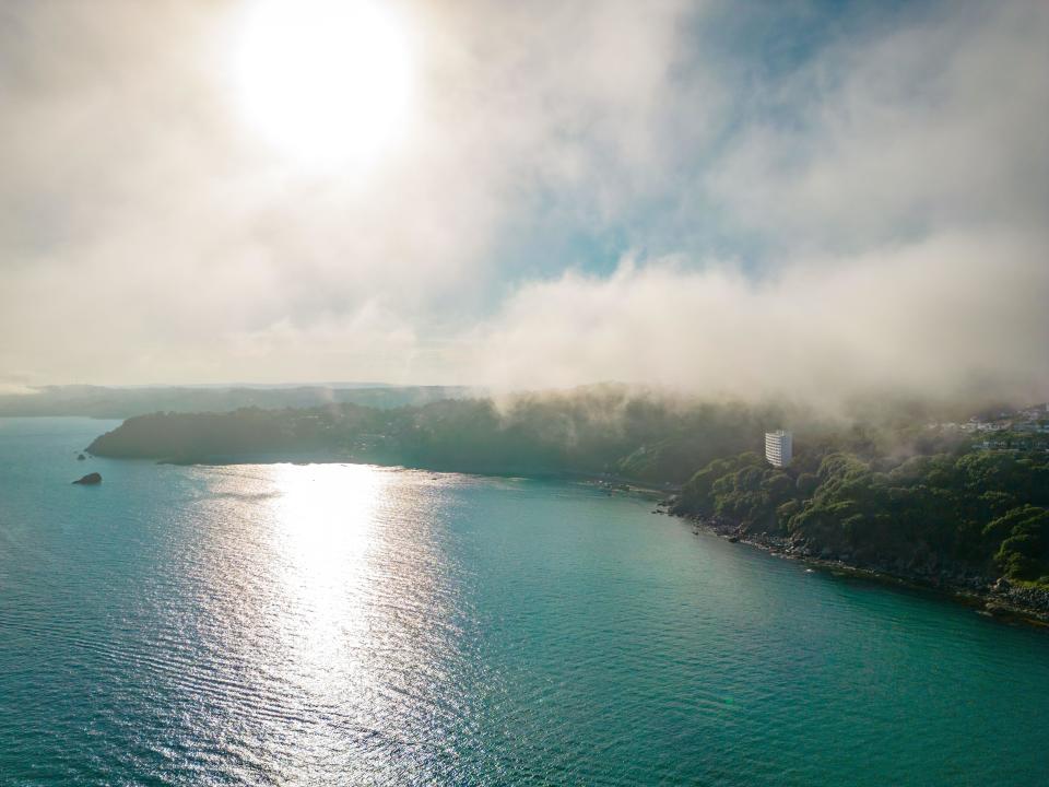 Torquay, UK. 24th June, 2023. A sea mist comes in over Torquay after a very hot day. Credit: Thomas Faull/Alamy Live News