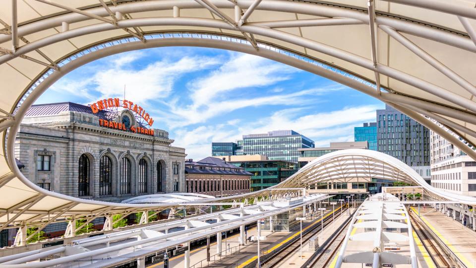 Denver, USA - A panoramic image showing the tracks of Denver's Union Station partially covered by the canopy architecture.