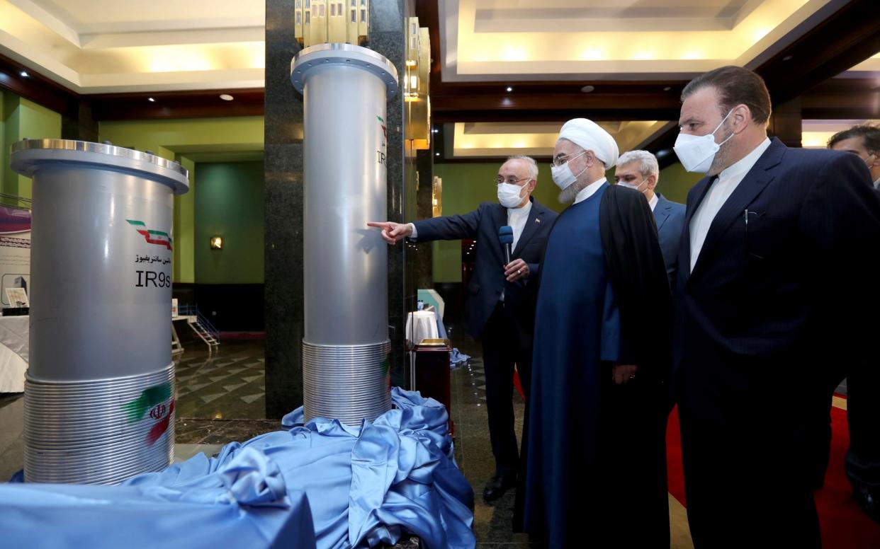 Iranian President Hassan Rouhani, second from right, listens to the head of the Atomic Energy Organisation of Iran Ali Akbar Salehi while visiting an exhibition of Iran's new nuclear achievements in Tehran - Iranian Presidency Office via AP