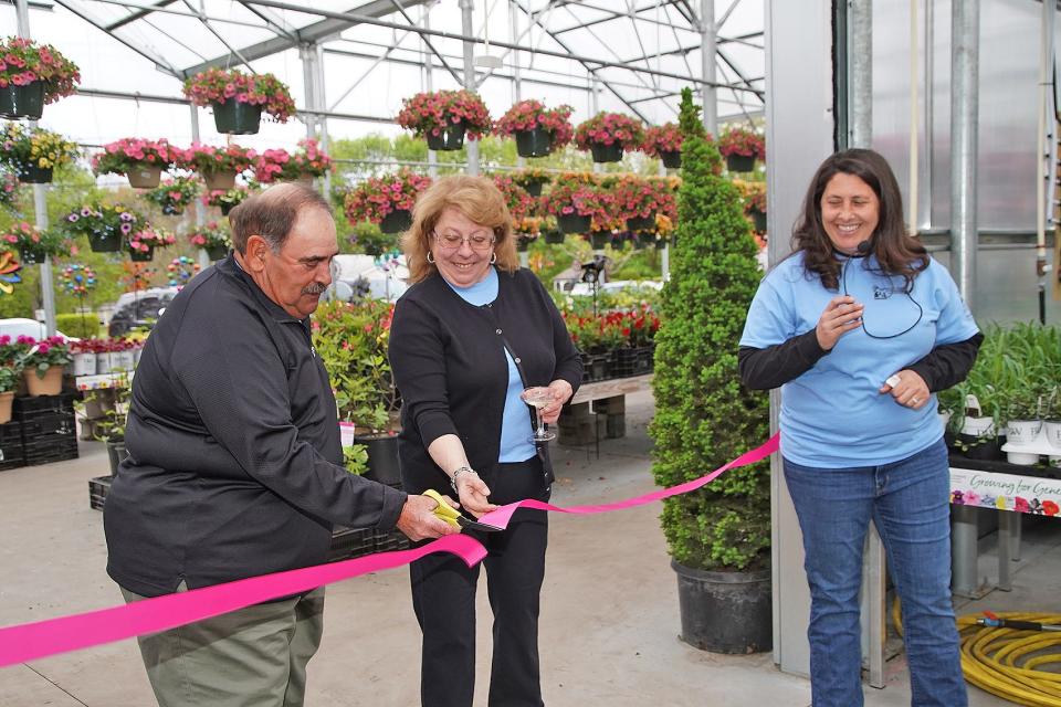 Ken and Darlene Araujo cut the ribbon as LeeAnne Araujo looks on during the grand reopening celebration at Araujo Farms in Dighton on Friday April 28, 2023.
