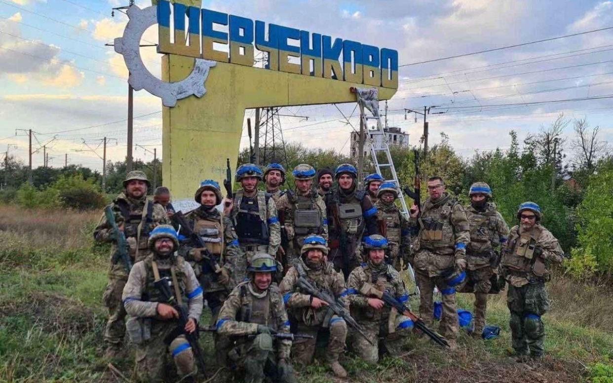 Ukrainian troops pose in the recently liberated settlement of Vasylenkove, in the Kharkiv region - TERRITORIAL DEFENCE OF THE UKRAINIAN ARMED FORCES