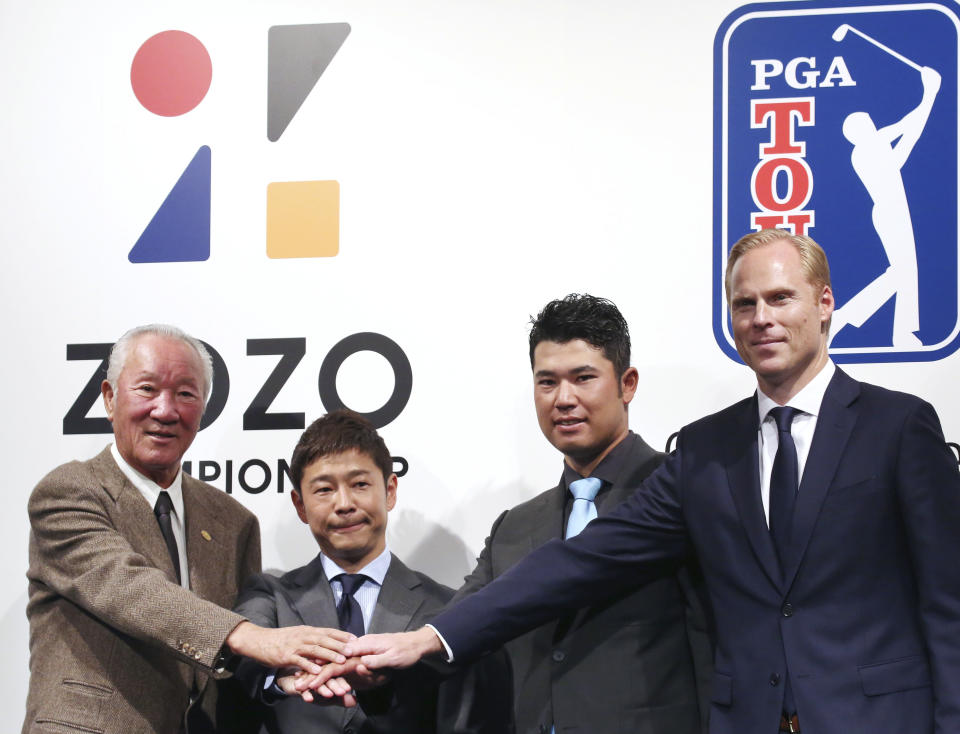 FILE - From left, Japan Golf Tour Organization President Isao Aoki, ZOZO Inc. President Yusaku Maezawa, PGA Tour Player Hideki Matsuyama and PGA Tour Vice President Christian Hardy join their hands while posing for a photo during a press conference in Tokyo, Tuesday, Nov. 20, 2018. The PGA Tour and European tour have a joint operating venture for the next 13 years. Now it appears they want the Japan Golf Tour to join them. (AP Photo/Koji Sasahara, File)