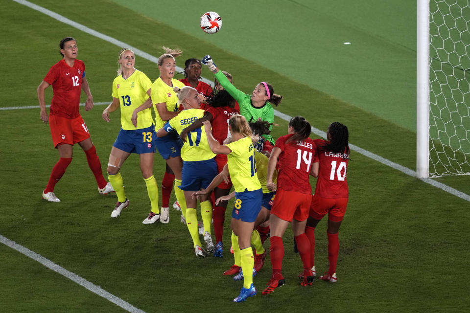 Canada's goalkeeper Stephanie Labbe, right, blocks a shot during the women's final soccer match against Sweden at the 2020 Summer Olympics, Friday, Aug. 6, 2021, in Yokohama, Japan. (AP Photo/Kiichiro Sato)