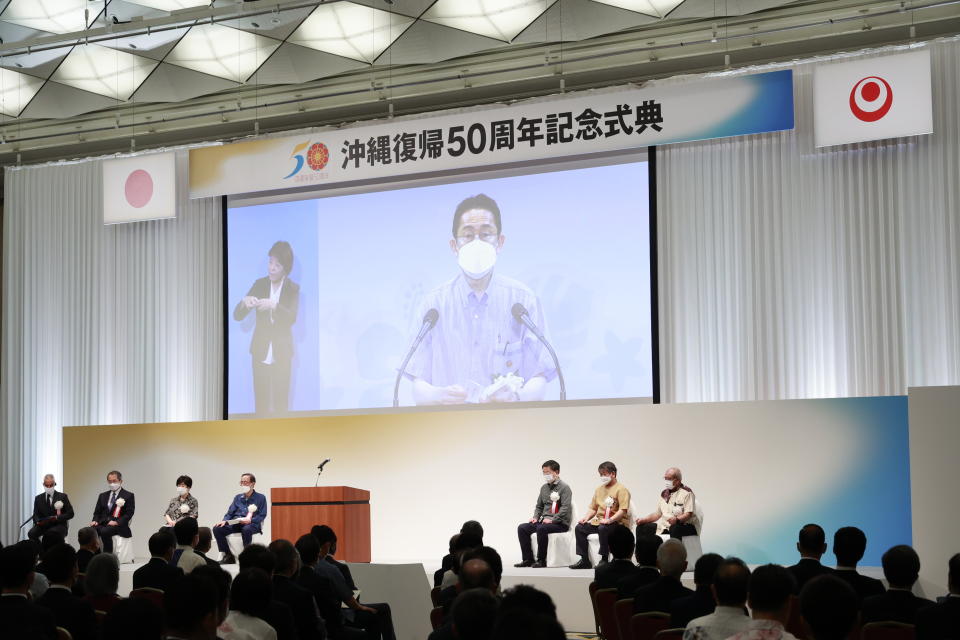 Japanese Prime Minister Fumio Kishida, seen on screen, delivers a video message during the ceremony to mark the 50th anniversary of Okinawa's return to Japan after 27 years of American rule Sunday, May 15, 2022 in Tokyo, Japan. The ceremony is held in Tokyo and Okinawa simultaneously for the first time. (Rodrigo Reyes Marin/Pool Photo via AP)