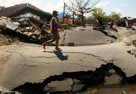 A man walks in an area damaged by an earthquake in Petabo, South Palu, Central Sulawesi, Indonesia, October 1, 2018, in this photo taken by Antara Foto. Antara Foto/Akbar Tado/ via REUTERS.