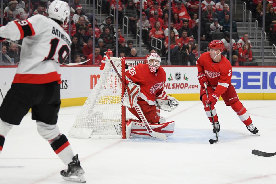 Senators right winger Drake Batherson (left) scores past Red Wings goalie Ville Husso (center) in the first period Dec. 17, 2022 at Little Caesars Arena in Detroit.